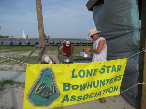 1986 Ford Bronco - Outdoor event with a banner for the Lone Star Bowhunters Association and a sailboat in the distance.