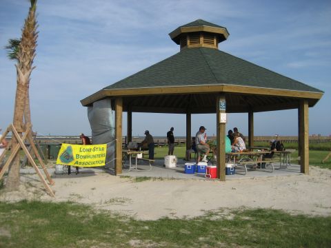1986 Ford Bronco - People gather under a beach pavilion with a banner for the Lone Star Bowhunters Association.