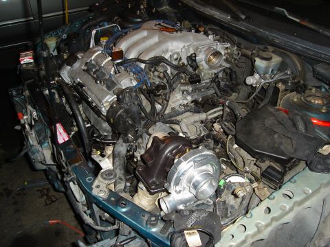 1995 Mazda MX-6 - Engine bay modifications, including a newly installed turbocharger, are visible in this close-up view.