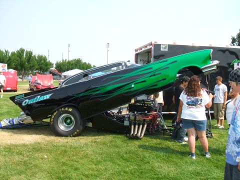 1974 Ford Ranchero - Custom drag car with exposed engine and flame graphics on display.
