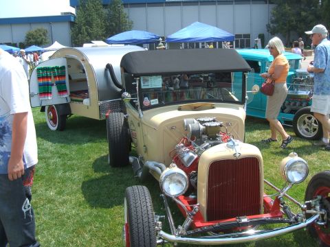 1974 Ford Ranchero - Hot rod and trailer at an outdoor car show event. Another car and people are in the background.