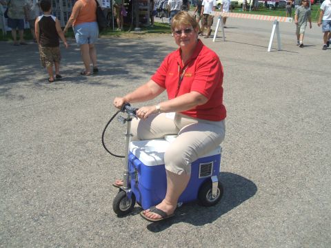 1974 Ford Ranchero - Woman rides a custom motorized cooler at an outdoor event.