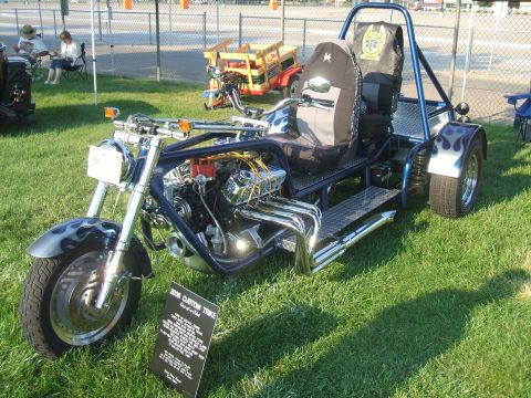 1974 Ford Ranchero - A custom-built trike with a V8 engine is displayed on a grassy lawn at an outdoor event.