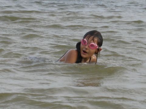 1986 Ford Bronco - A young girl with pink goggles swims in the water.
