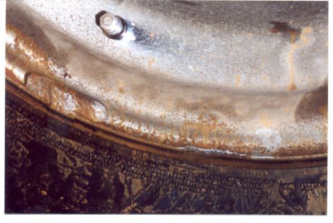 1989 Ford Bronco - Detail of a heavily rusted wheel rim and tire tread, showing signs of wear and age.