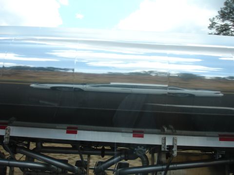 1993 Ford Taurus - The reflection on the tanker truck shows a white car, but it is not a 1993 Ford Taurus.