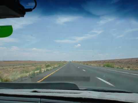 1993 Ford Taurus - Driving on a highway through a dry, open landscape with sparse vegetation.