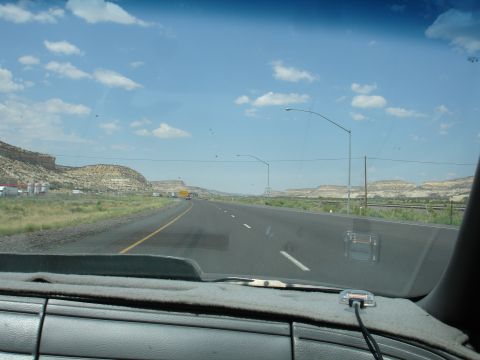 1993 Ford Taurus - Driving on a highway through a desert landscape under a partly cloudy sky.