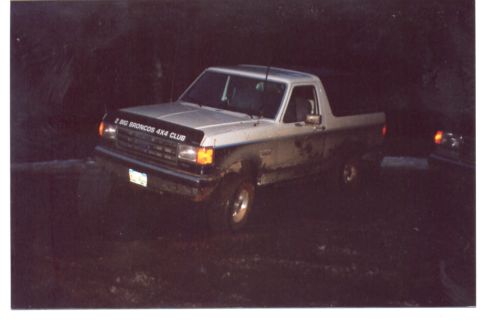 1989 Ford Bronco - This 1989 Ford Bronco is shown in a 3/4 front view, parked in an off-road setting.