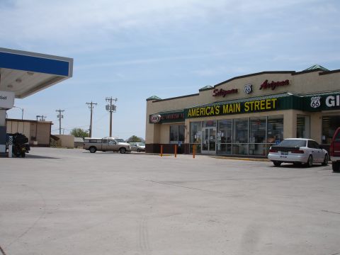1993 Ford Taurus - A white sedan is parked in front of a gas station and convenience store with Route 66 signage.