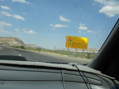 1993 Ford Taurus - Driving into New Mexico, passing a welcome sign on a sunny day with a clear blue sky.