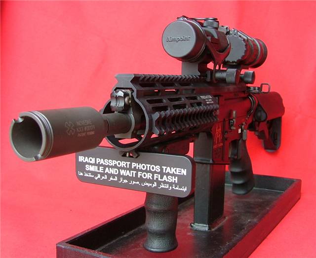 Custom AR-style rifle with Aimpoint optic on a stand against red background