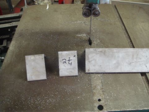 1996 Ford Bronco - Metal stock marked with '2t' sits on a band saw table, ready for cutting.