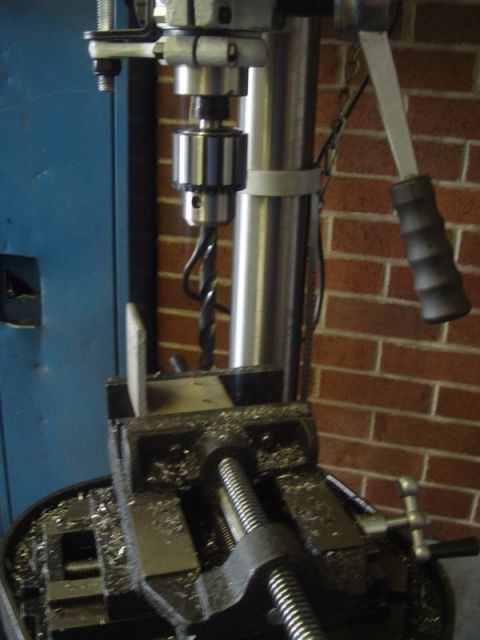 1996 Ford Bronco - Close-up of a drill press with a metal vise and shavings, ready for use.