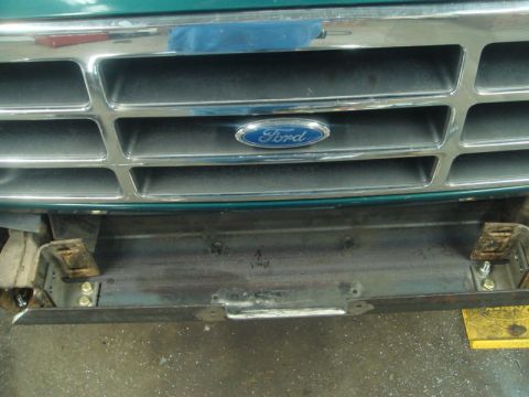 1996 Ford Bronco - Close-up of a Ford truck grille and the start of a custom bumper installation.