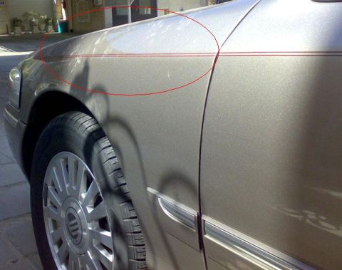 2007 Mercury Grand Marquis - Side view of a 2007 Mercury Grand Marquis, highlighting the fender and wheel area.