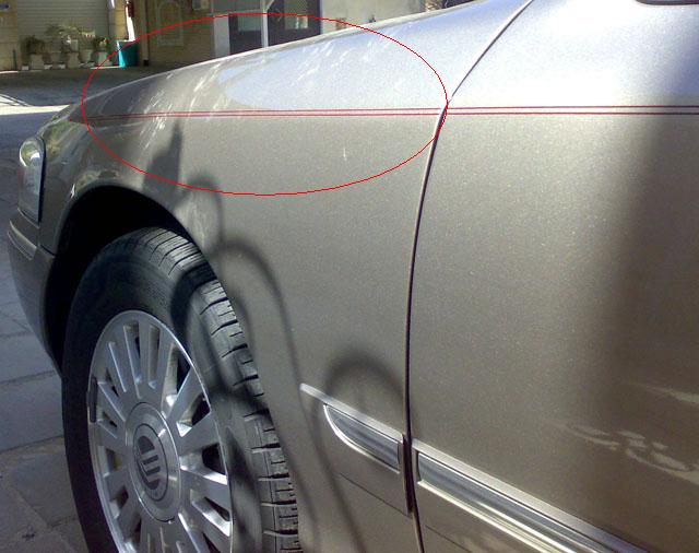 2007 Mercury Grand Marquis side view showing fender, wheel, and pinstripes