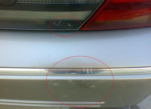 2007 Mercury Grand Marquis - Scratches are visible on the rear bumper and taillight of this 2007 Mercury Grand Marquis.