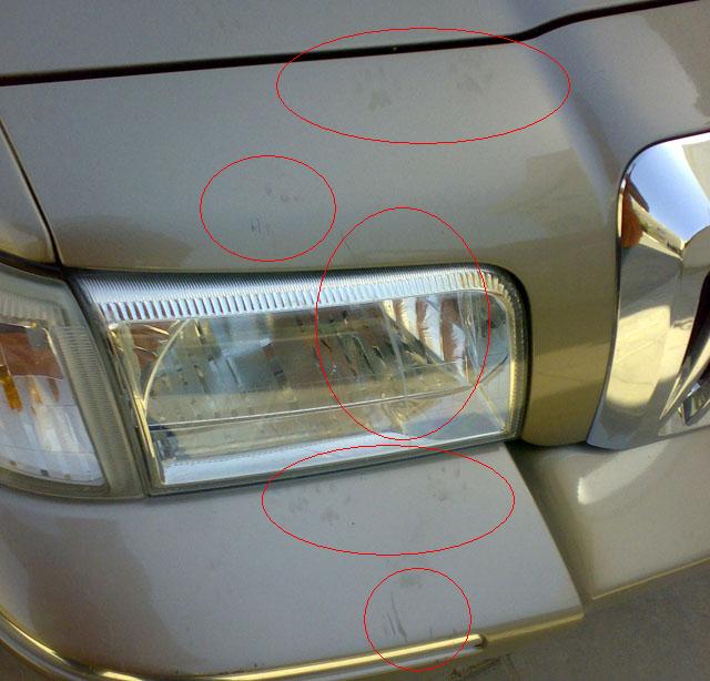 2007 Mercury Grand Marquis front bumper and headlight with scuff marks circled
