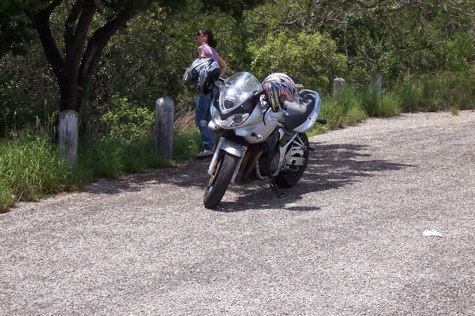 2003 Suzuki Bandit S motorcycle parked on gravel with a person standing nearby
