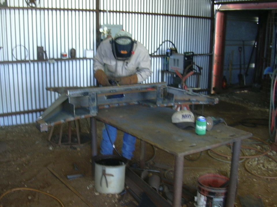 Metal custom front bumper being welded in a workshop