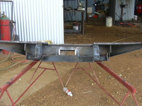 1995 Ford Bronco - Custom steel bumper fabrication in progress, supported by sawhorses in a workshop setting.