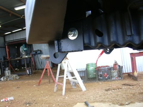 1995 Ford Bronco - Close-up view of a custom front bumper mounting bracket and bolt.