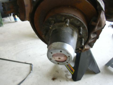 1995 Ford Bronco - Front wheel hub assembly with a manual locking mechanism is visible, supported by a jack stand.