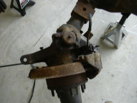 1995 Ford Bronco - A rusty Ford Bronco solid axle assembly is shown on jack stands, indicating it is a vehicle part.