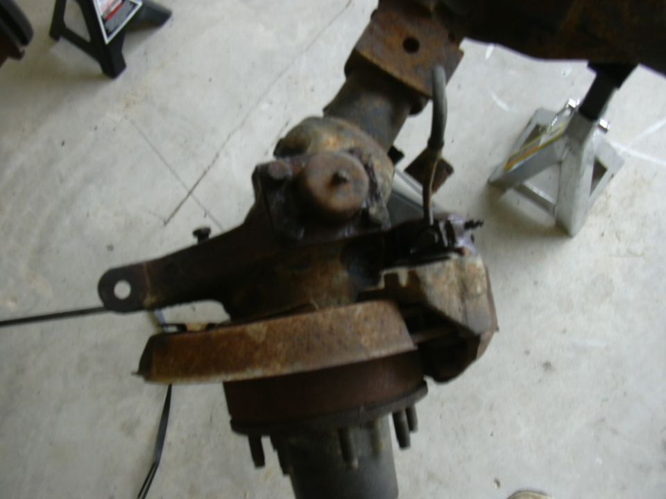 Rusty Ford Bronco solid axle assembly on jack stands
