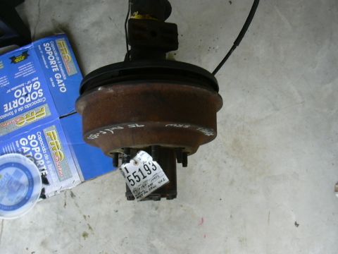 1995 Ford Bronco - A rusty front axle assembly is shown with a white identification tag attached.