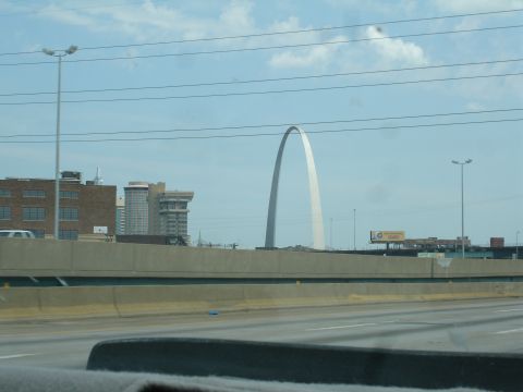 1993 Ford Taurus - The Gateway Arch stands tall against a cloudy sky, with city buildings visible in the background.
