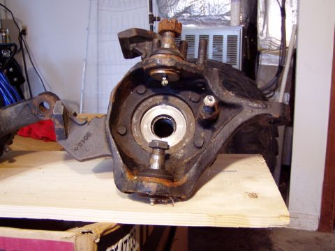 1989 Ford F-250 - This is a close-up view of a disassembled truck spindle and knuckle assembly, showing the bearing race and mounting bolts.