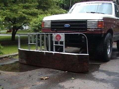 1990 Ford Bronco - This 1990 Ford Bronco is equipped with a custom plow and a fire department emblem on the front.