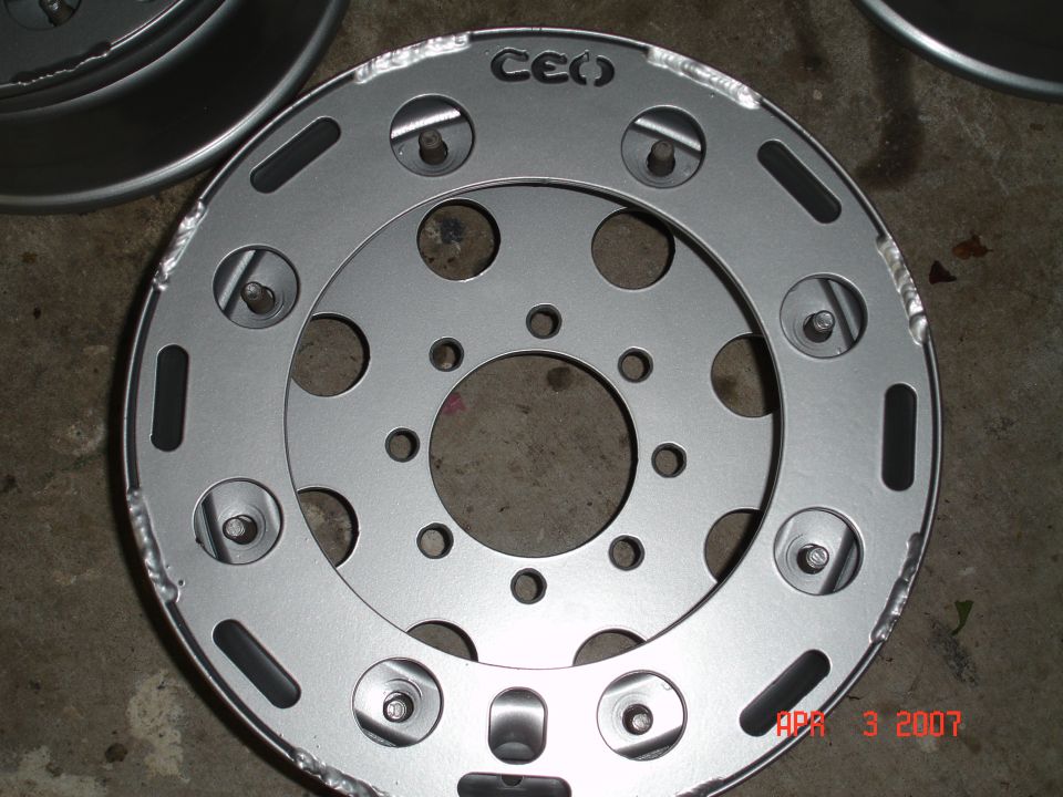 Silver metal wheel rim with 'CEO' logo and multiple bolt holes
