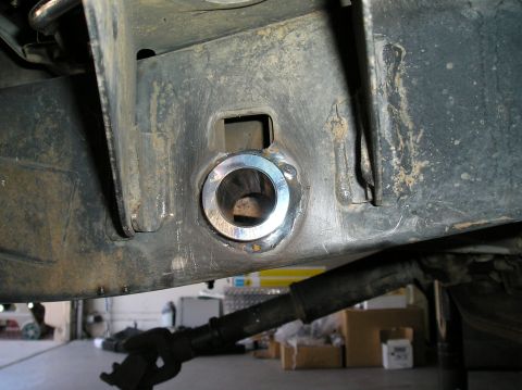 1986 Toyota Hilux - Vehicle frame with a new suspension bushing installed, showing metalwork and part of the shock absorber.