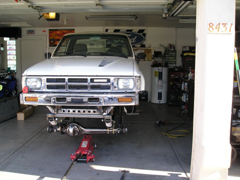 1986 Toyota Hilux - Front suspension removed from a 1986 Toyota Hilux, showing the chassis and lifted front end.