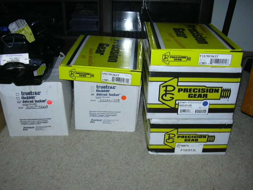 Boxes of Precision Gear and Truetrac Detroit Locker parts stacked on carpet