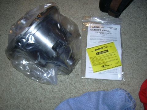 1995 Ford Bronco - A new NoSPIN locker and its accompanying documentation are laid out on a carpeted floor.
