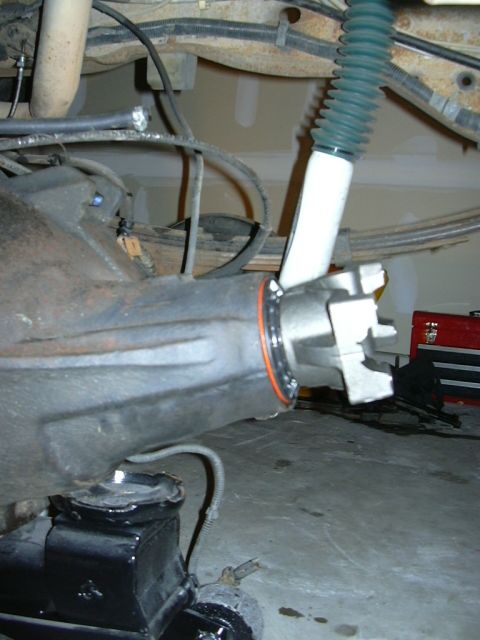 1995 Ford Bronco - Detail of a vehicle's rear axle assembly, showing the differential housing and shock absorber.