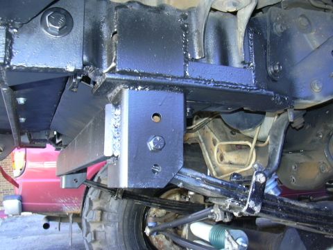 1995 Ford Bronco - Custom suspension brackets are welded onto the frame, showing a modification to the vehicle's undercarriage.