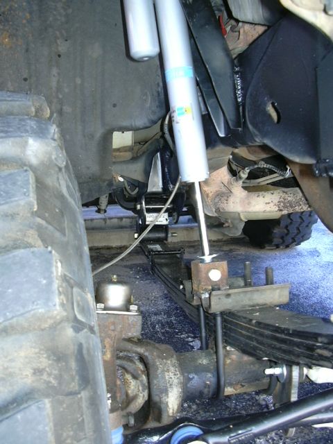 1995 Ford Bronco - This image shows the undercarriage of a vehicle, focusing on the suspension system and large tires.