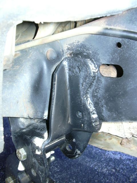 1995 Ford Bronco - Detail of a welded bracket attached to the vehicle's chassis, showing mounting points.