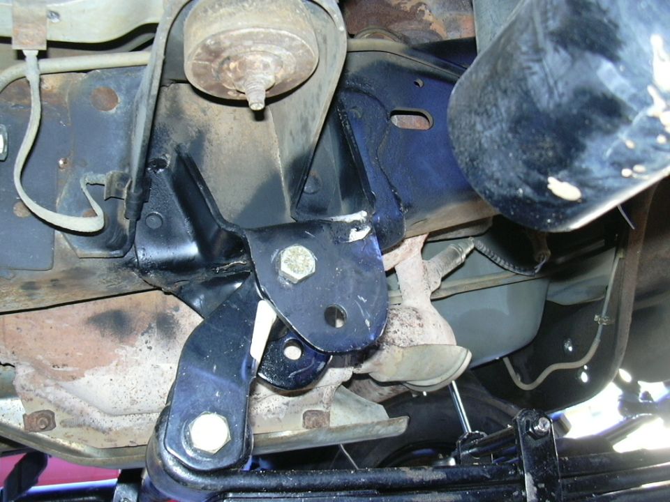 close-up of vehicle suspension parts, likely a solid axle swap modification