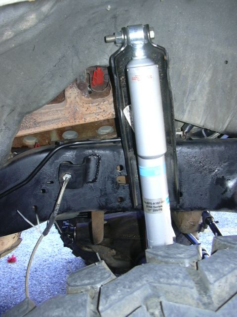 1995 Ford Bronco - Close-up of a shock absorber and suspension components, showing text indicating "Bilstein 9100 Series".