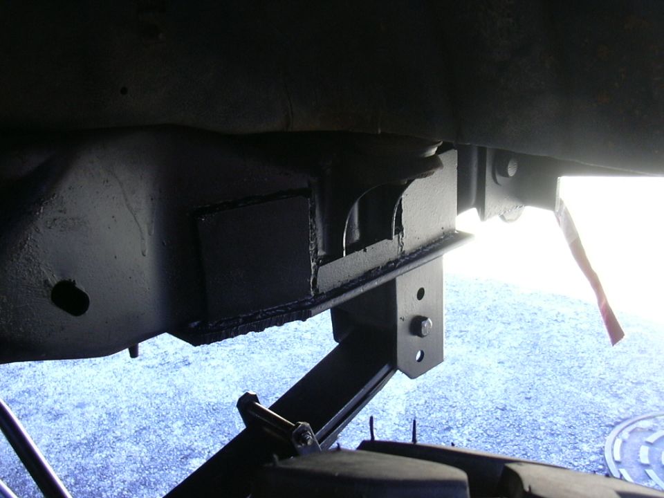 Undercarriage view of a solid axle swap modification on a vehicle