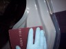 1998 Ford Crown Victoria - A red book is held within a clear plastic bag by a gloved hand.