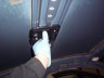 1998 Ford Crown Victoria - Close-up of a hand holding an electronic device inside a vehicle's cabin.