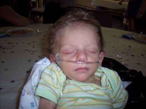 1972 Ford Ranchero - A child sleeps peacefully at a table, wearing a nasal cannula.