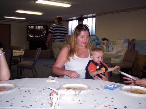 1972 Ford Ranchero - A woman holds a baby while seated at a table decorated with confetti and plates.